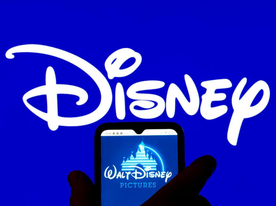迪士尼标志在蓝色背景上的手机前面与华特迪士尼图片标志